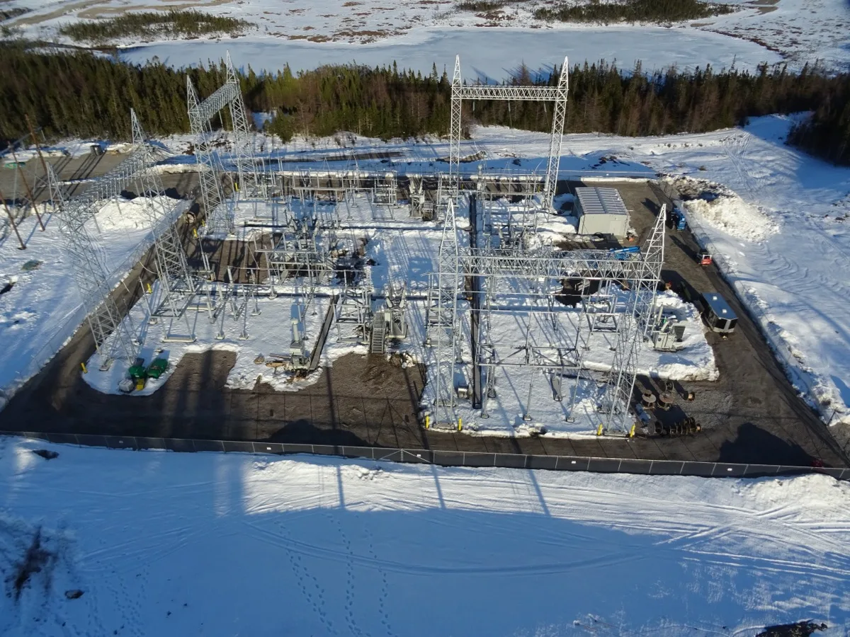 Aerial view of a high-voltage substation under construction in winter, Newfoundland
