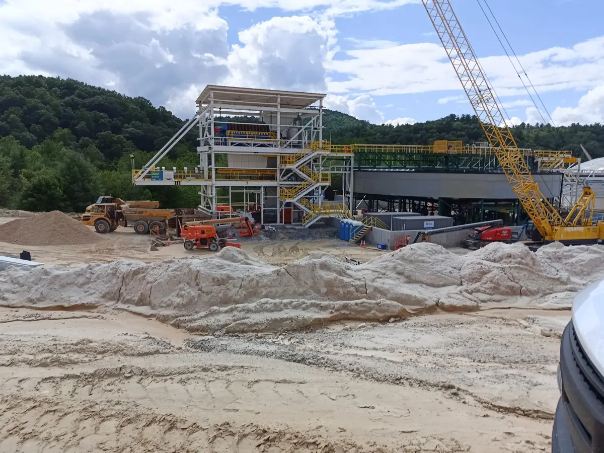 Mineral processing plant under construction with new steel tower, thickener and crawler crane, North Carolina